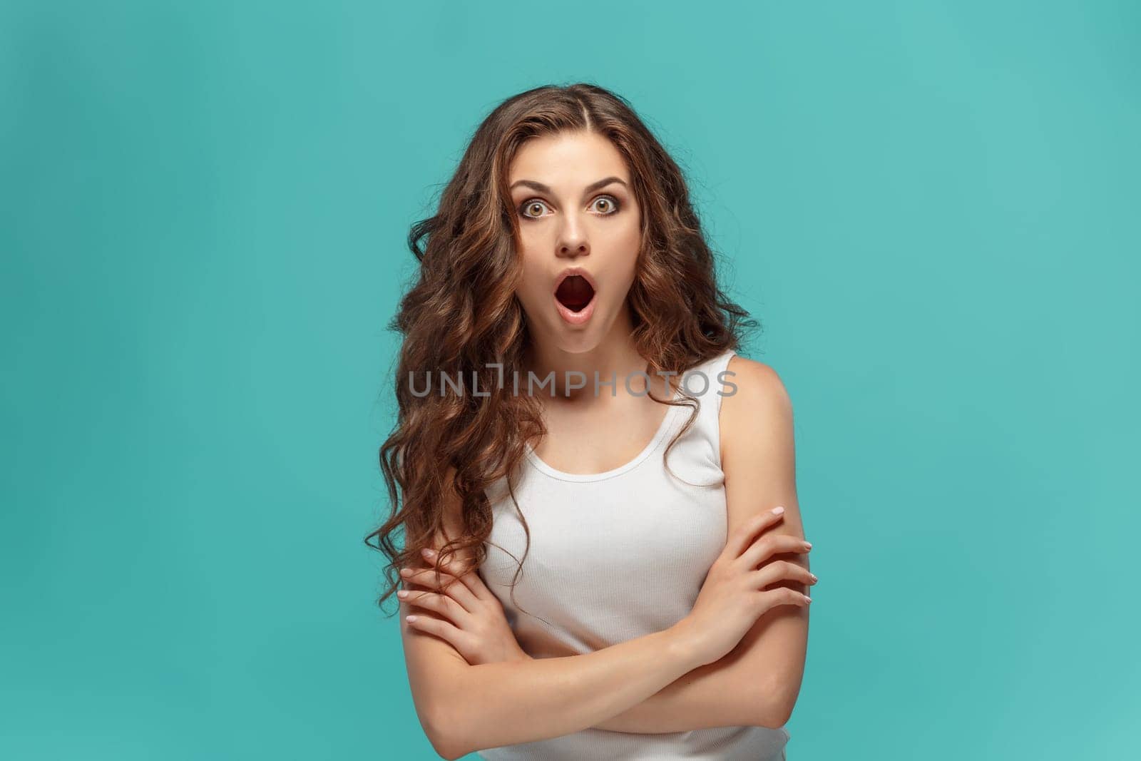 The portrait of young woman with shocked facial expression