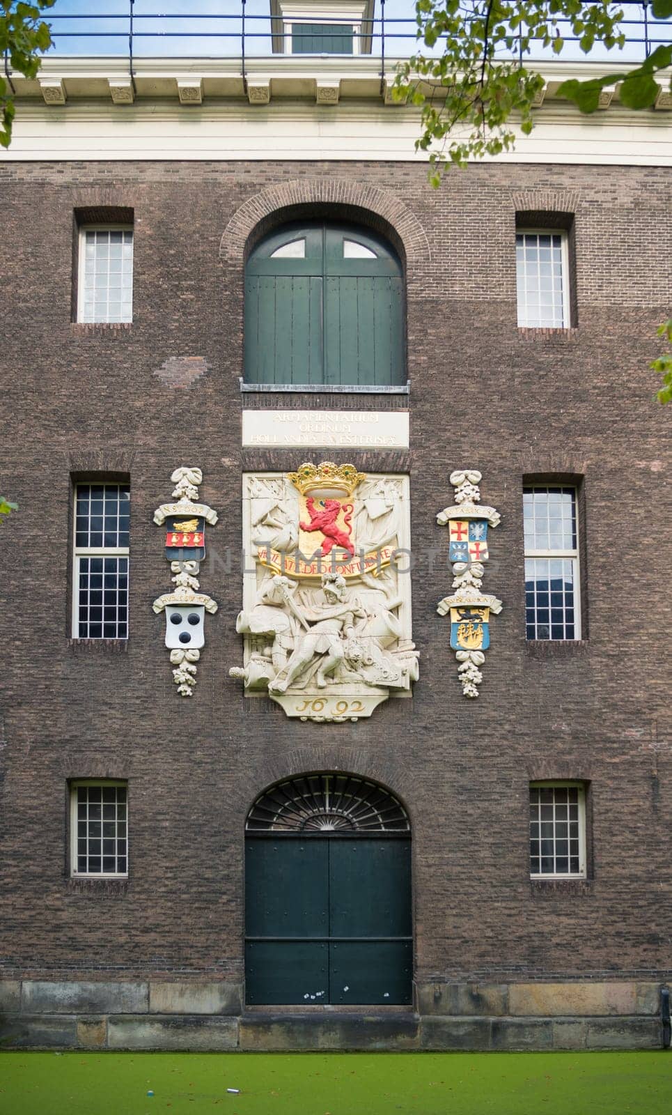 DELFT, NETHERLANDS - SEPTEMBER 18, 2016: Emblem on an old warehouse in the center of the city. The city is famous because of its association with the royal House of Orange-Nassau.