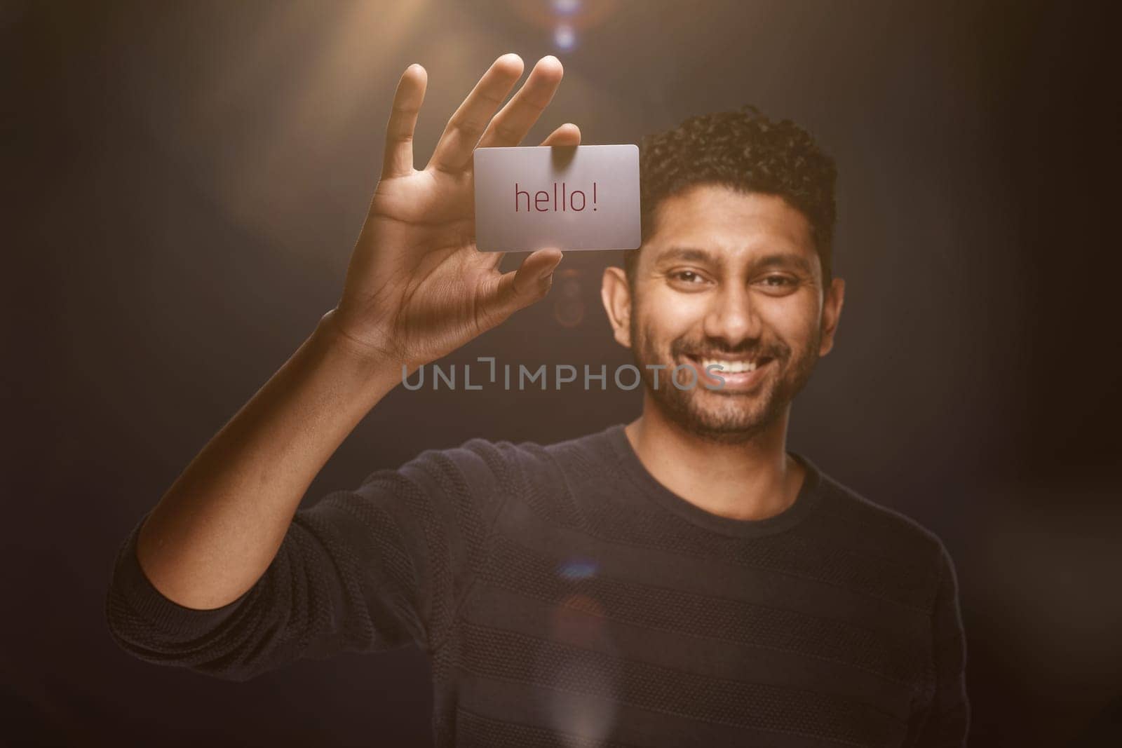 Smiling man from Sri Lanka shows business card with copyspace