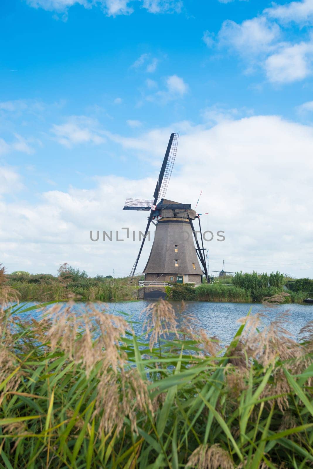 windmill along a canal in the netherlands