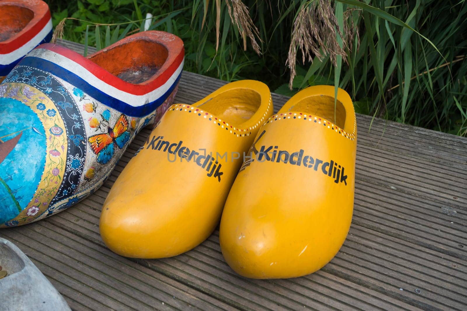 KINDERDIJK, NETHERLANDS - SEPTEMBER 18, 2016: Pair of wooden shoes for tourists to take pictures