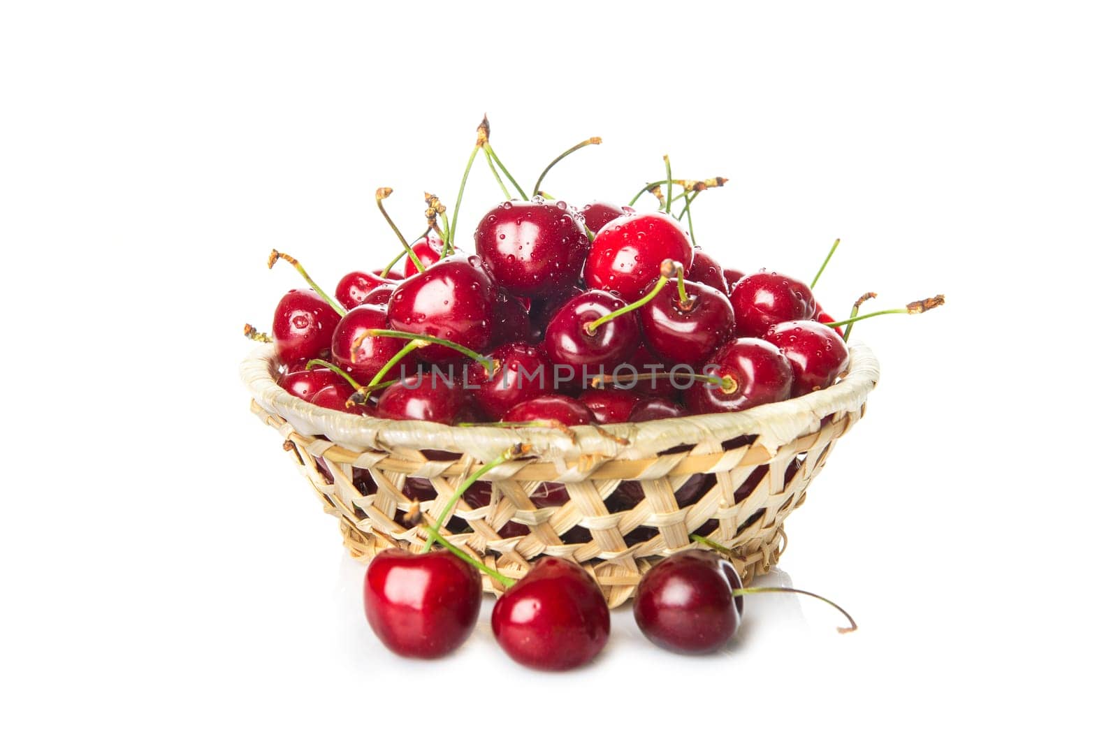 Basket with fresh cherries isolated on a white background