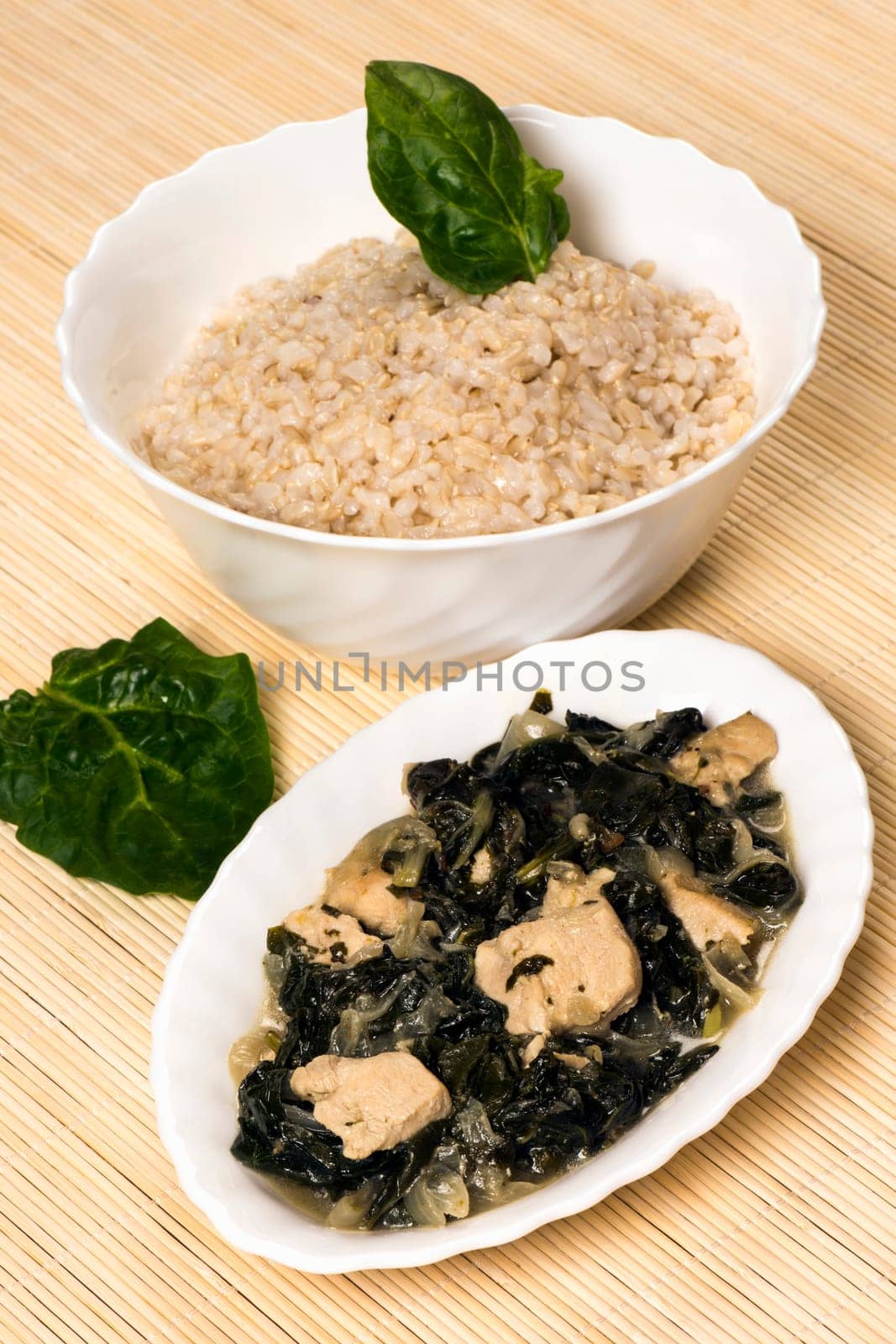 Chicken with mangold and spinach and a bowl of rice is Asian food.