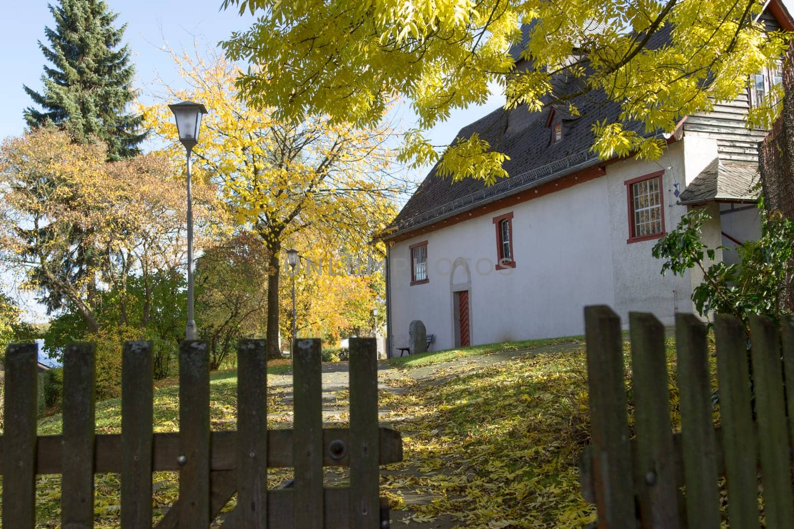 Old church in Hessian village in autumn landscape