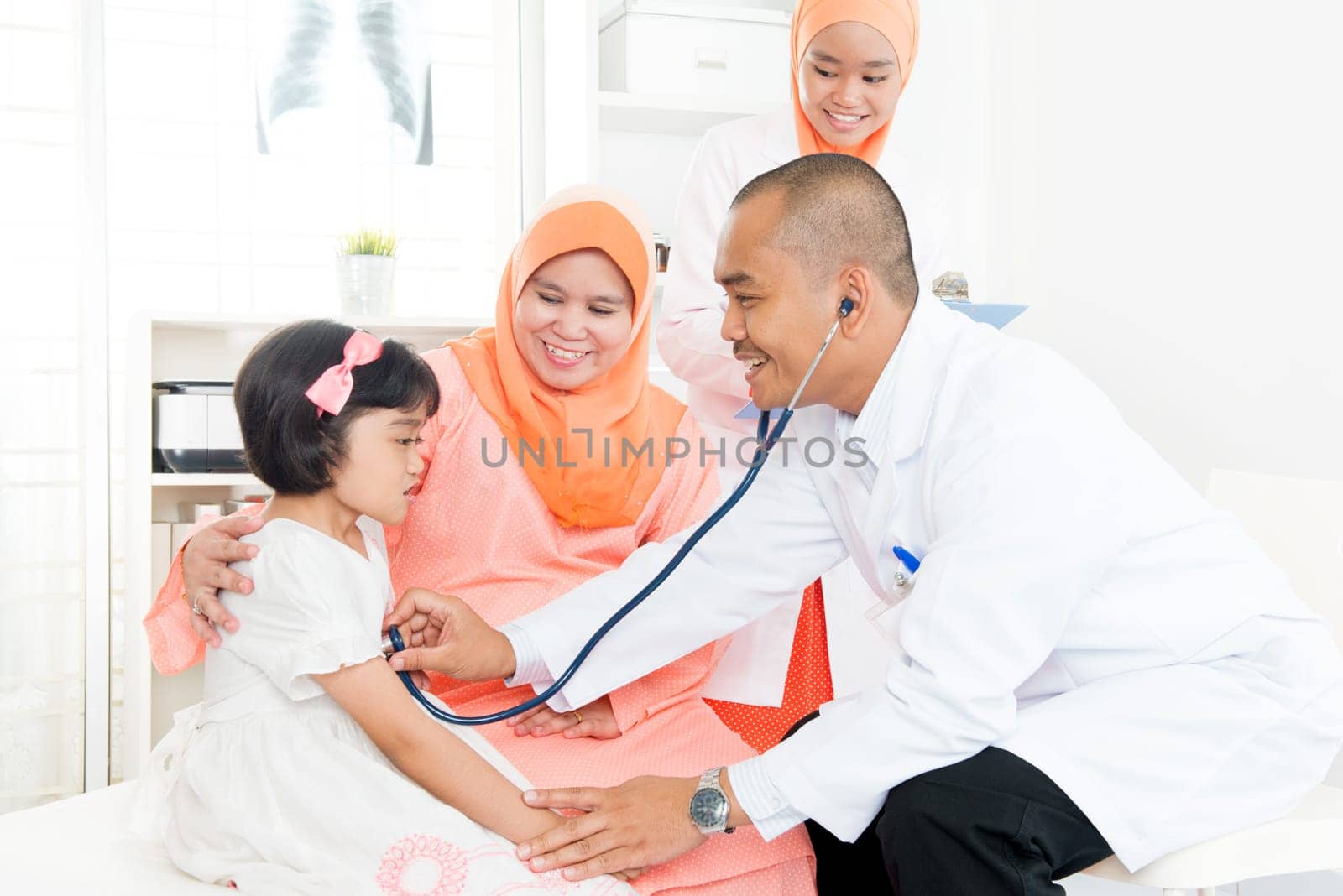 Illness Southeast Asian child patient consulting medical doctor. Muslim family.