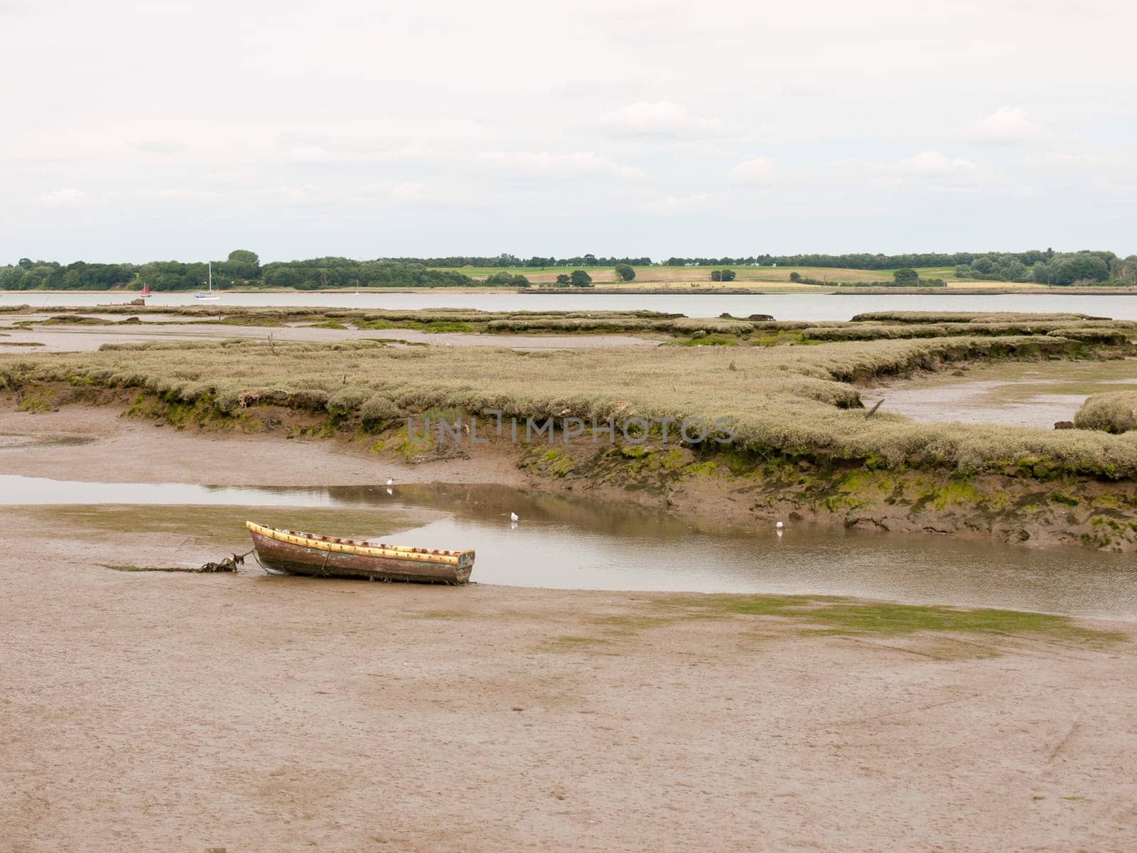single old boat in mud sea coast no people browns