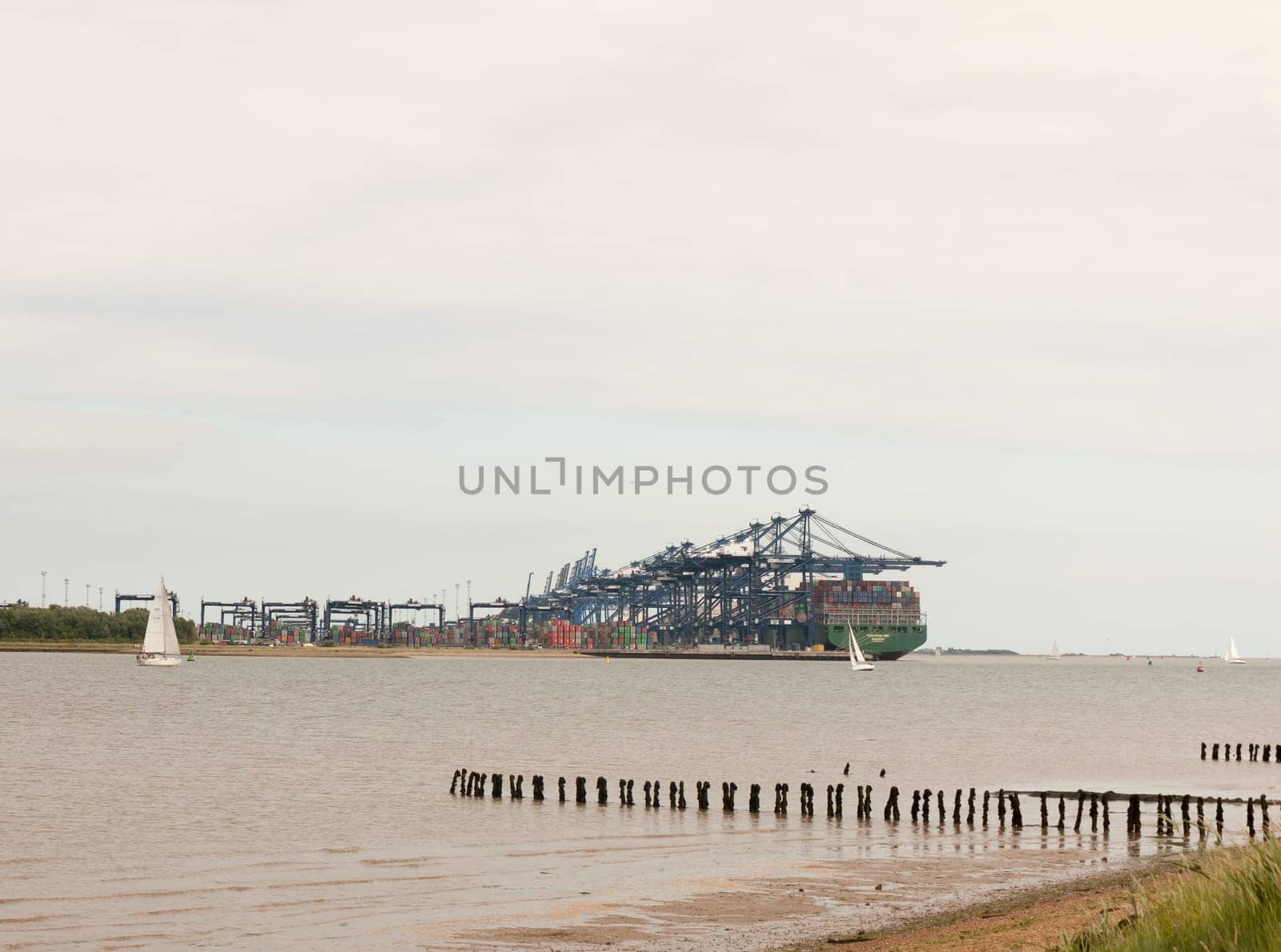 blue sea structure cranes at cargo dock loading in distance felixstowe essex