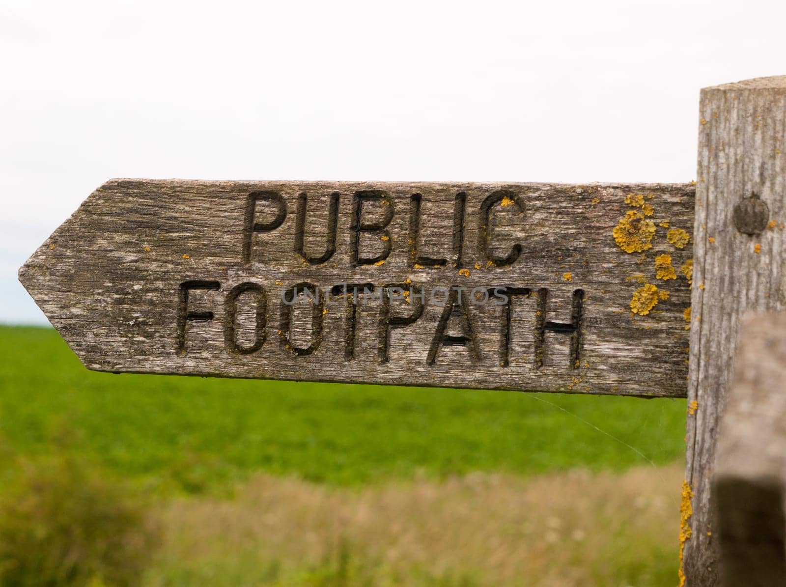 public footpath wooden sign outside leading way country