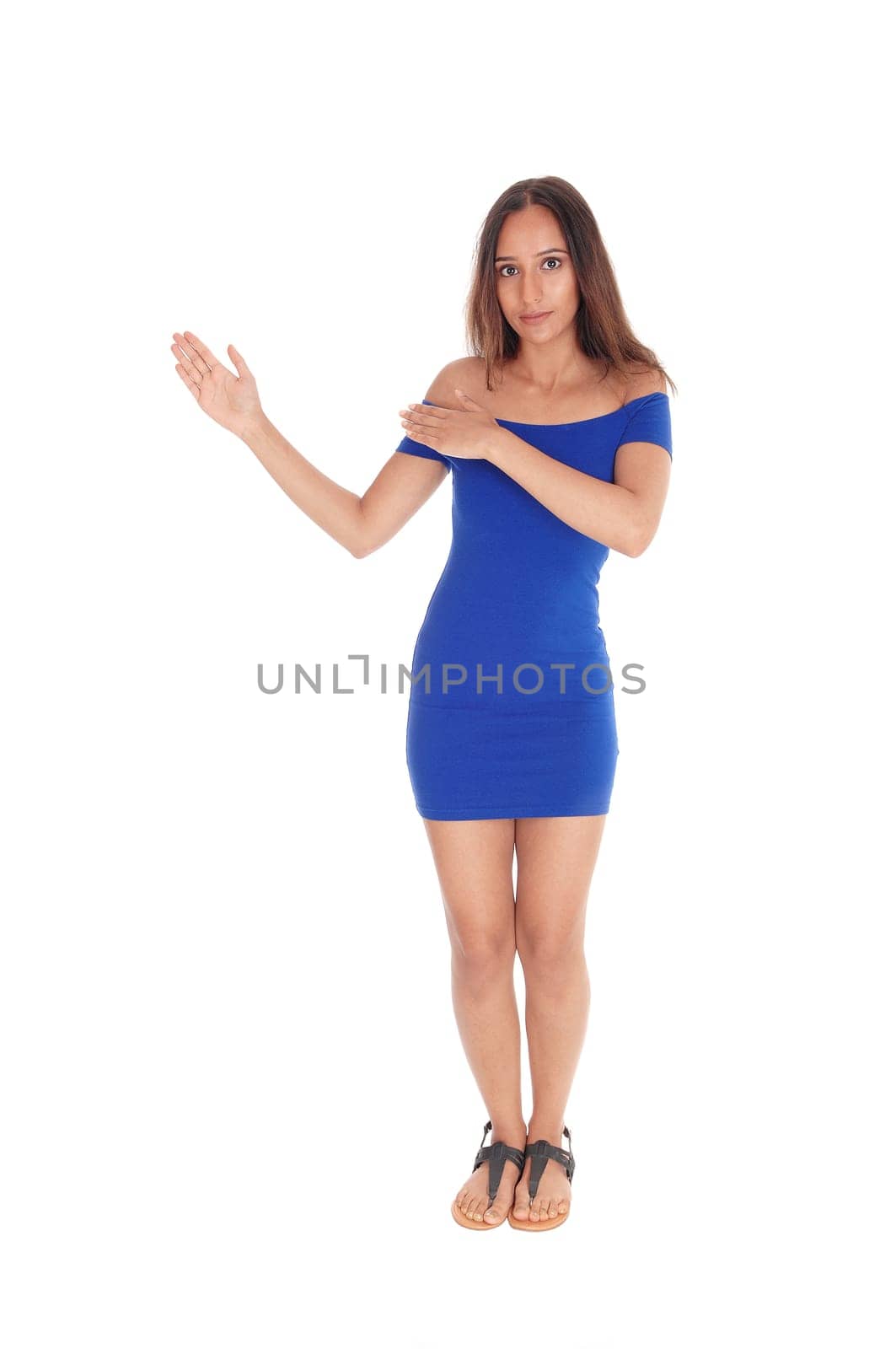A beautiful young East Indian woman standing in a blue dress and.showing the way with her hands, isolated for white background..