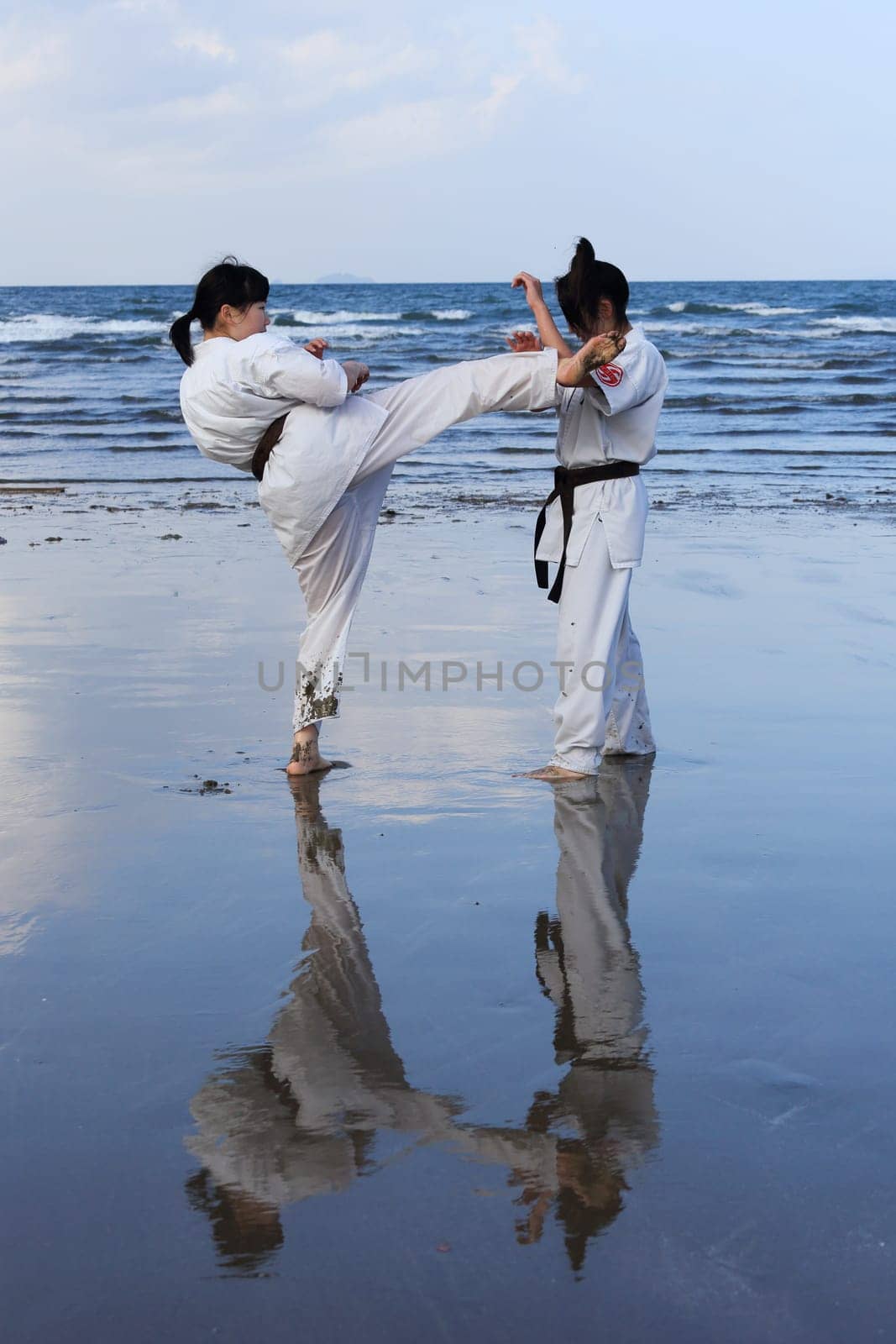 Kagawa, Japan - January 3, 2017: Japanese martial arts houses, young girls training of karate at the new year at the Ichinomiya beach.