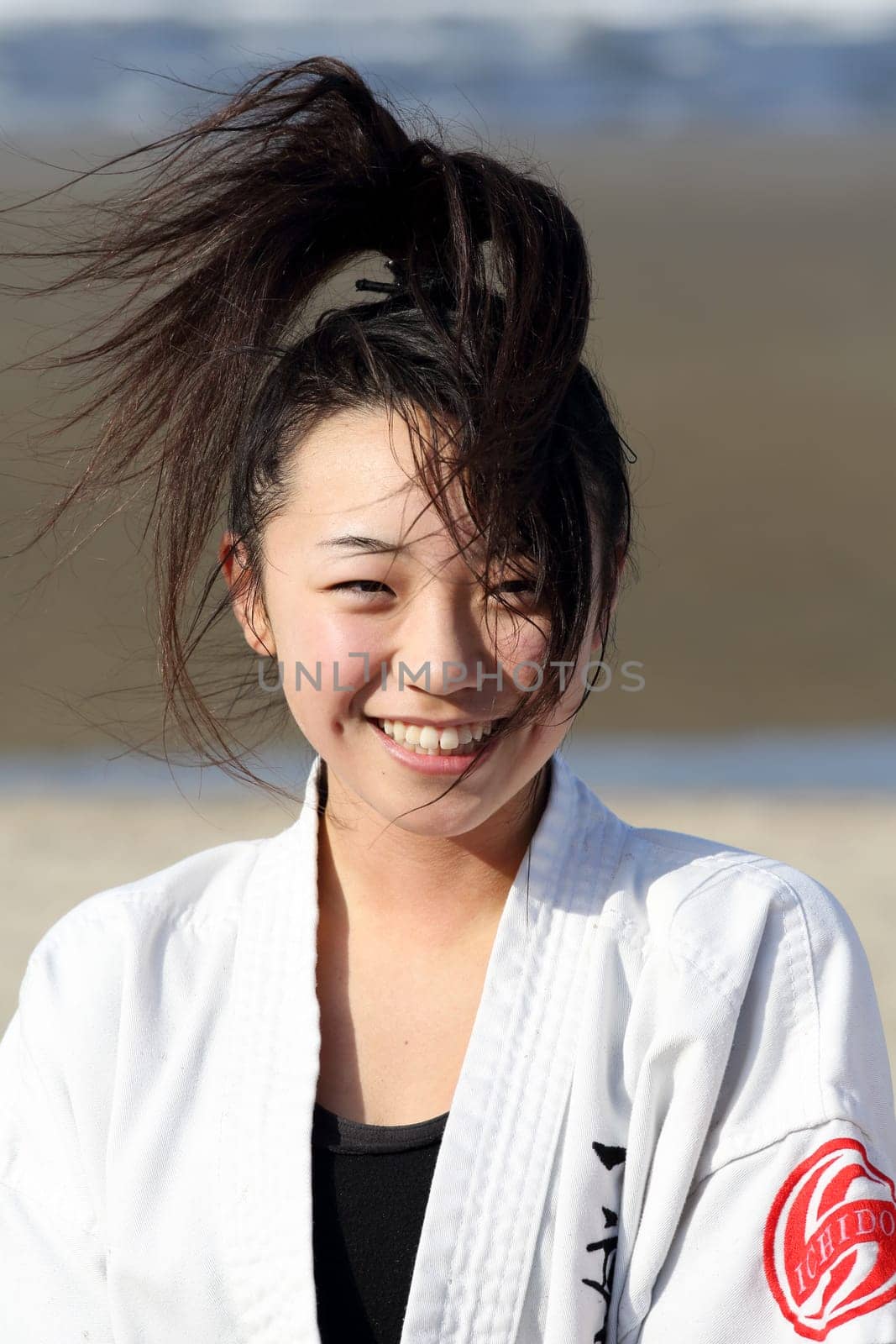 Kagawa, Japan - January 3, 2017: Japanese martial arts houses, young girl training of karate at the new year at the Ichinomiya beach.