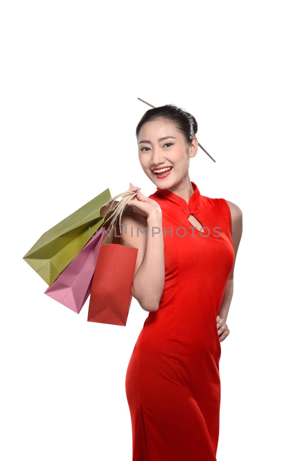 Chinese woman in cheongsam dress holding shopping bag. Chinese new year concept