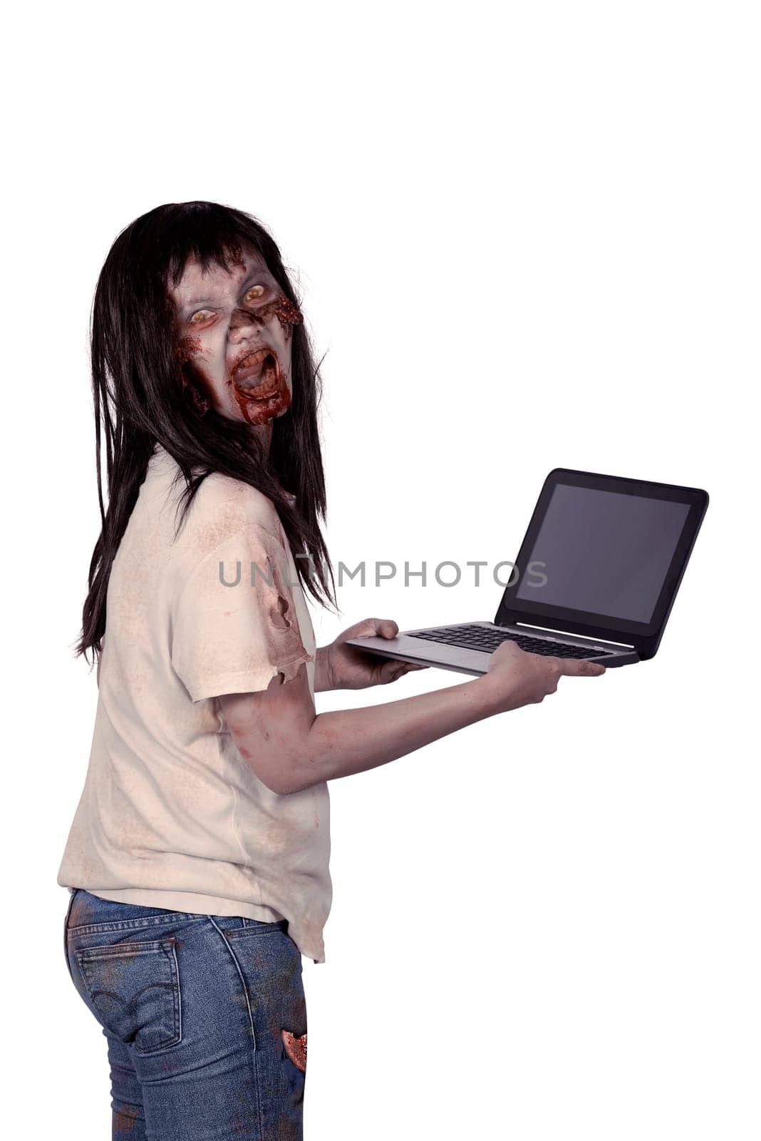 Scary female zombie holding laptop isolated over white background