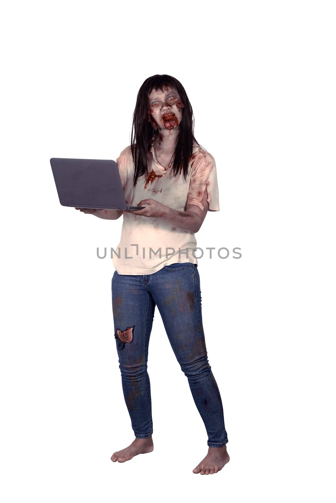 Female zombie holding laptop isolated over white background