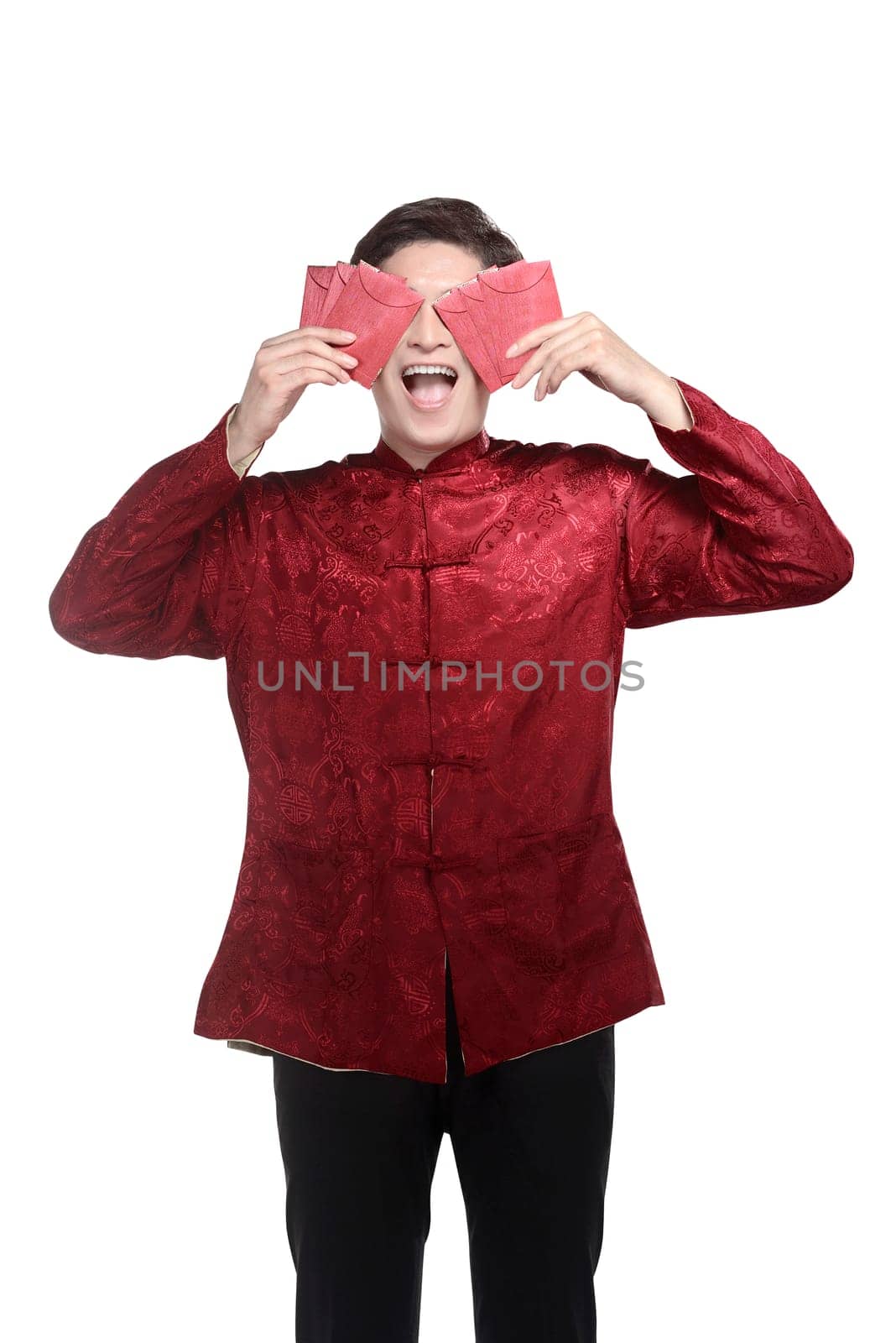 Young chinese man in cheongsam suit holding angpao, isolated over white background
