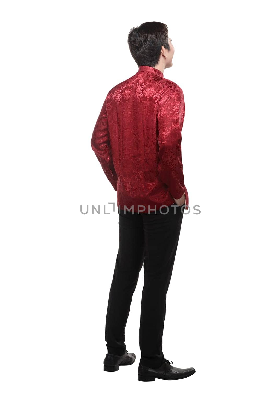 Back view of young chinese man in cheongsam suit isolated over white background