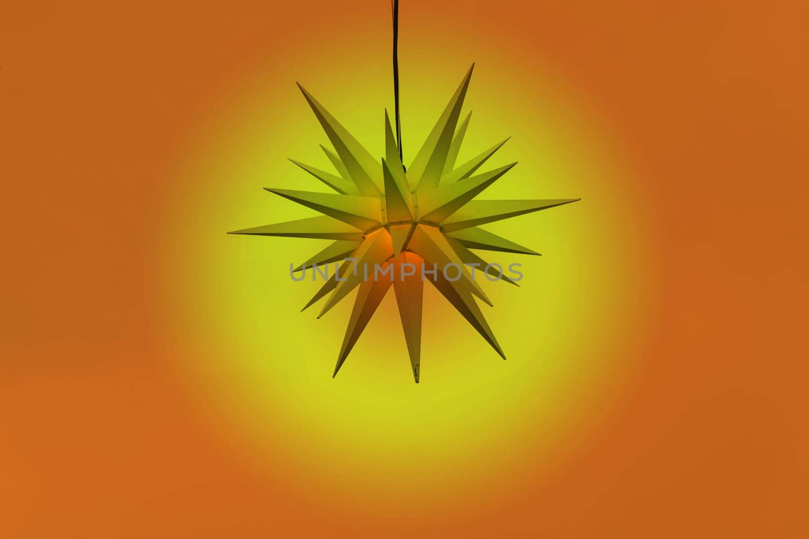 Illuminated poinsettia against a gradient background..