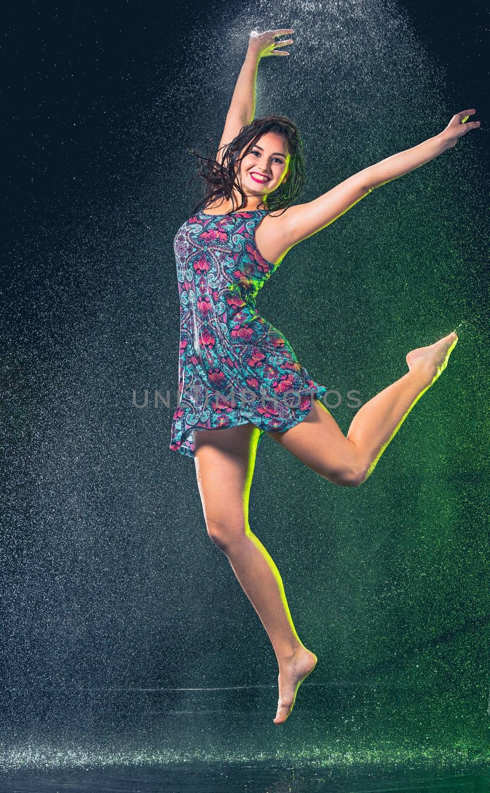 Young beautiful woman with splash of rain. Studio shot