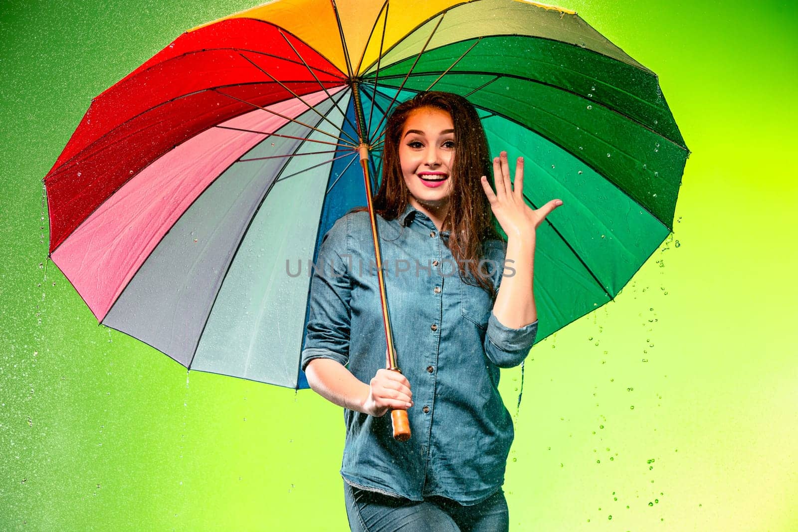Young beautiful woman with an umbrella. Studio shot