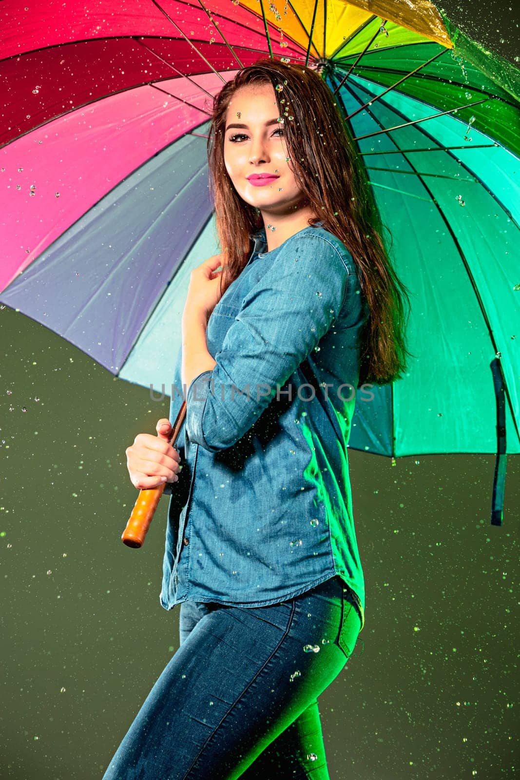 Young beautiful woman with an umbrella. Studio shot