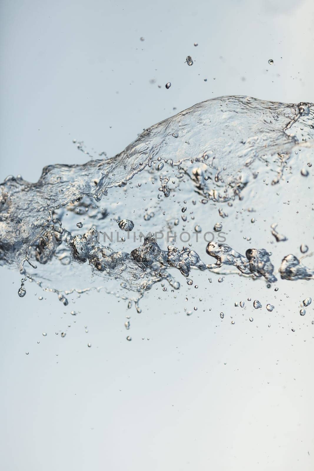 Splashes of water in the air against a bright background