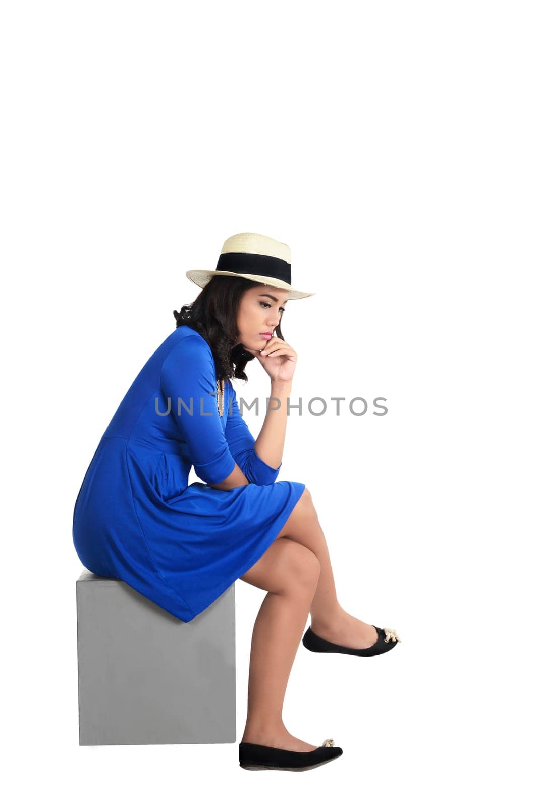 Asian woman wearing hat sitting and look sad