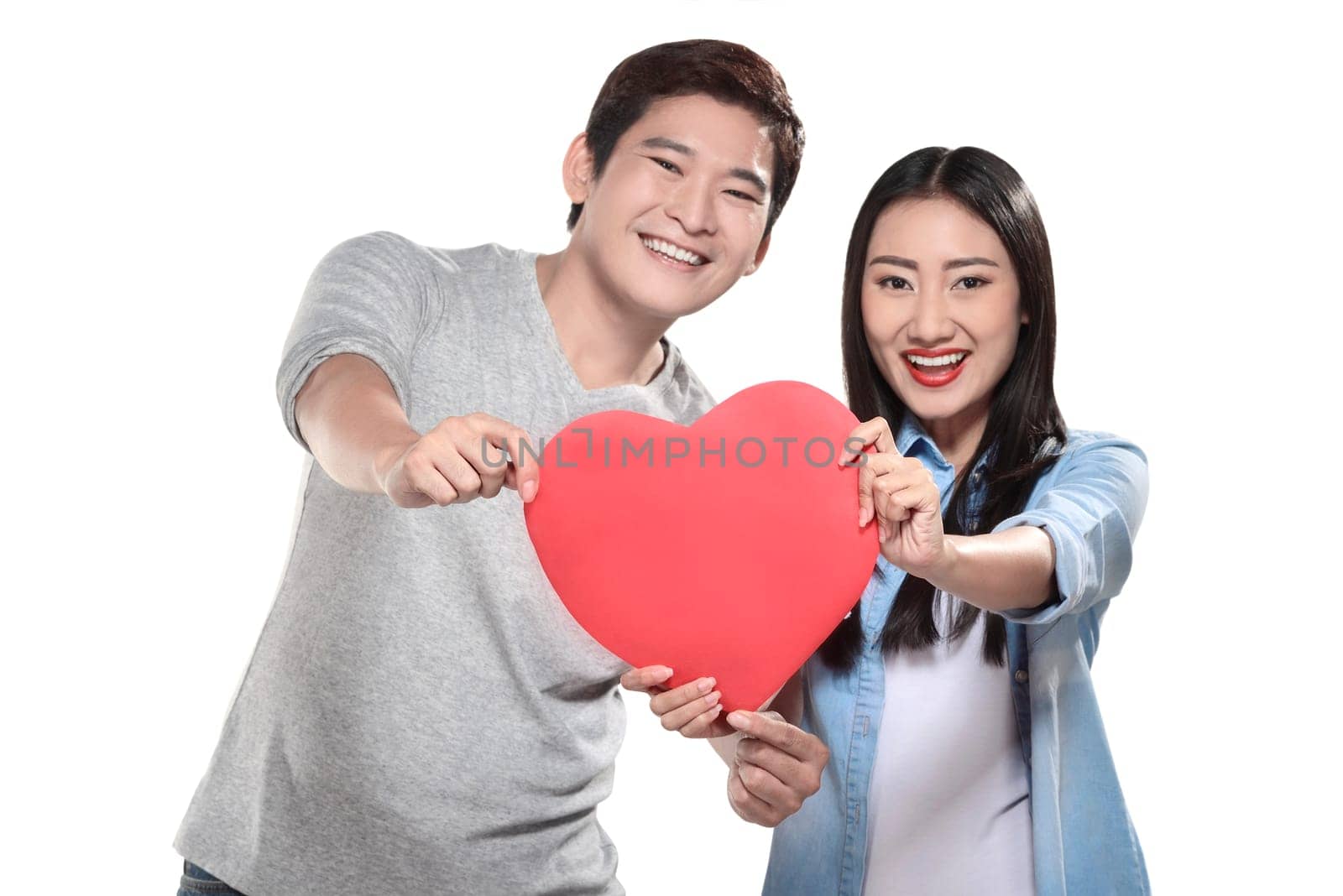 Valentine couple concept. Portrait of man and woman holding red heart