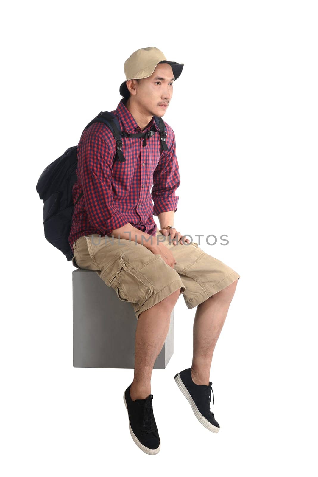 Sitting traveler man isolated over white background