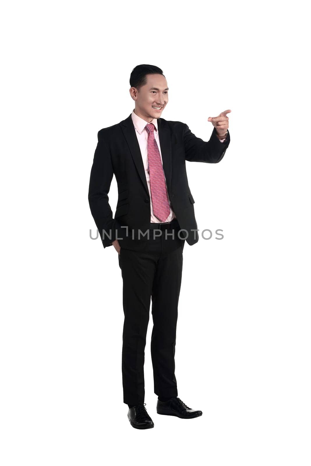 Asian business man pointing something isolated over white background