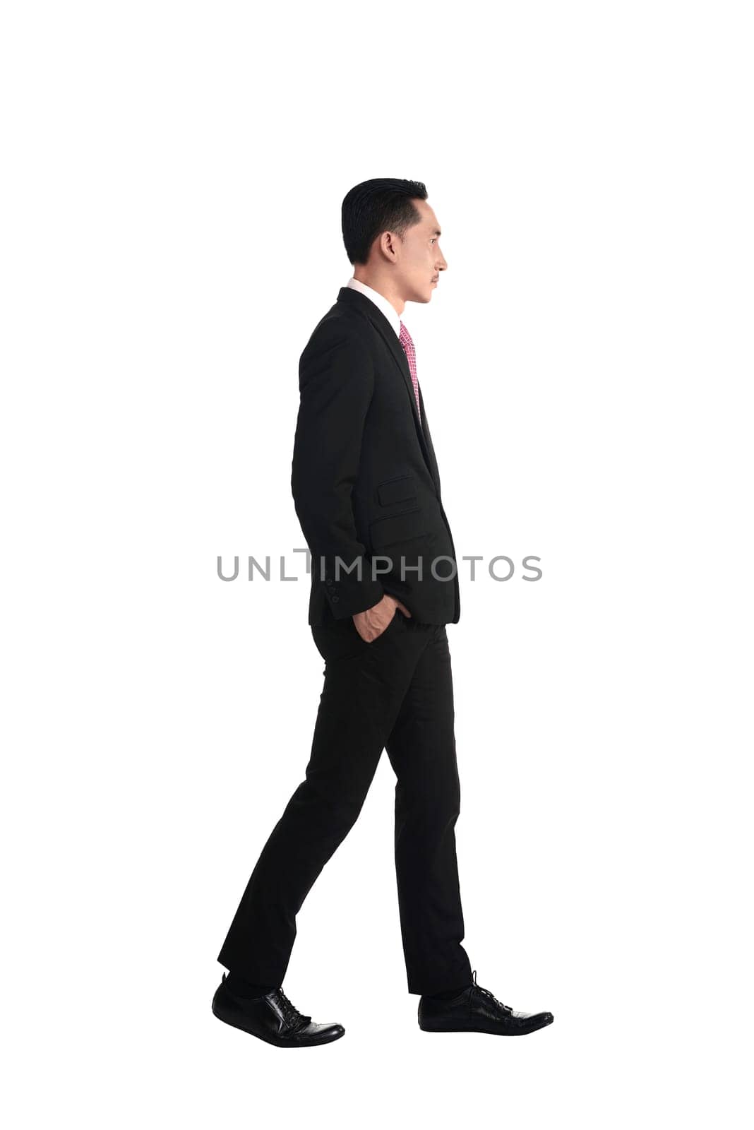 Asian business man walking isolated over white background