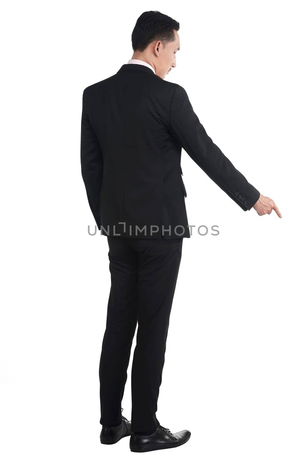 Asian business man pointing something down isolated over white background