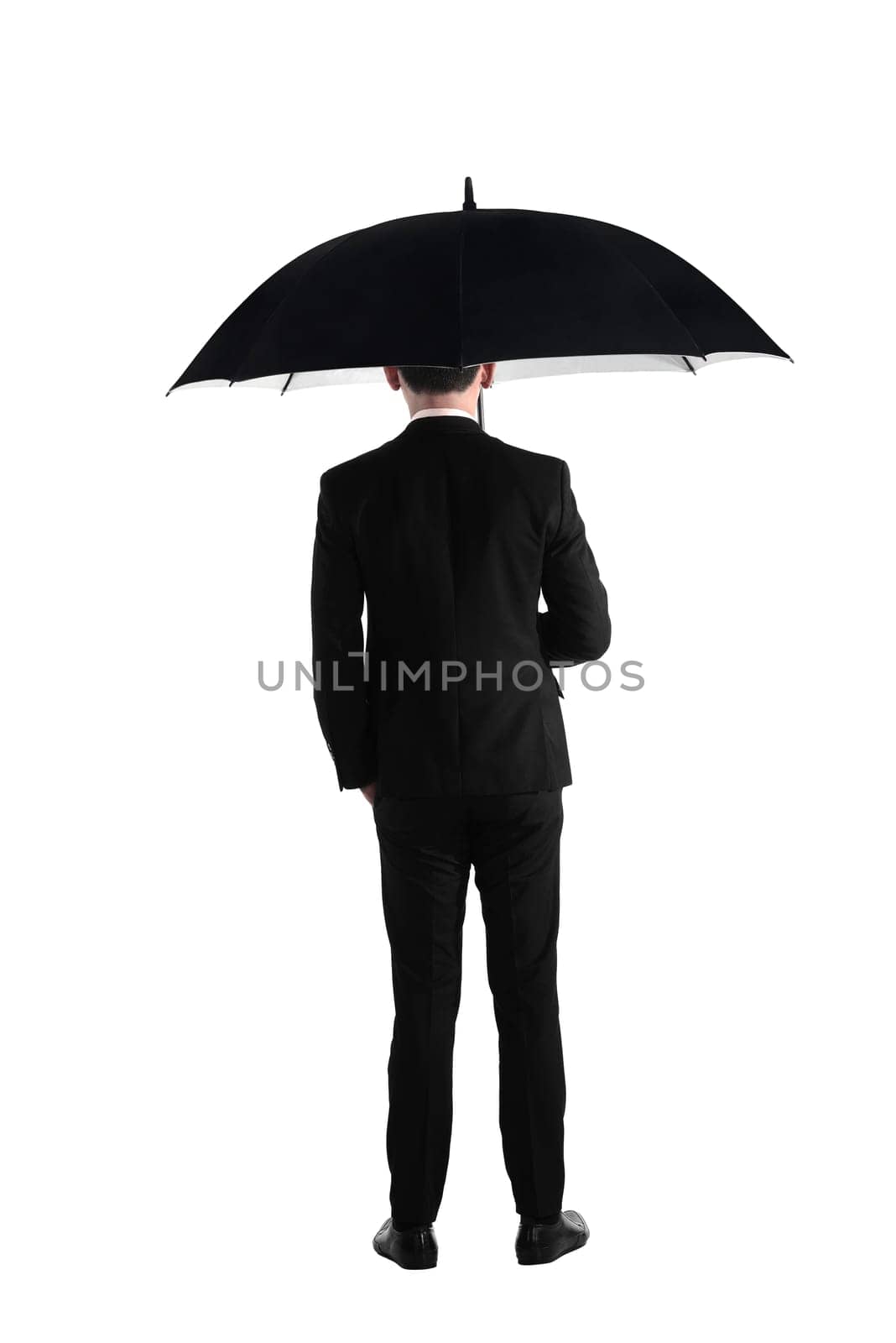 Back view business man standing holding umbrella isolated over white background