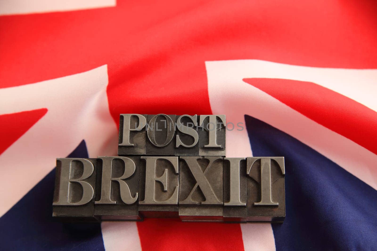 UK flag with post Brexit words in metal type with room for text