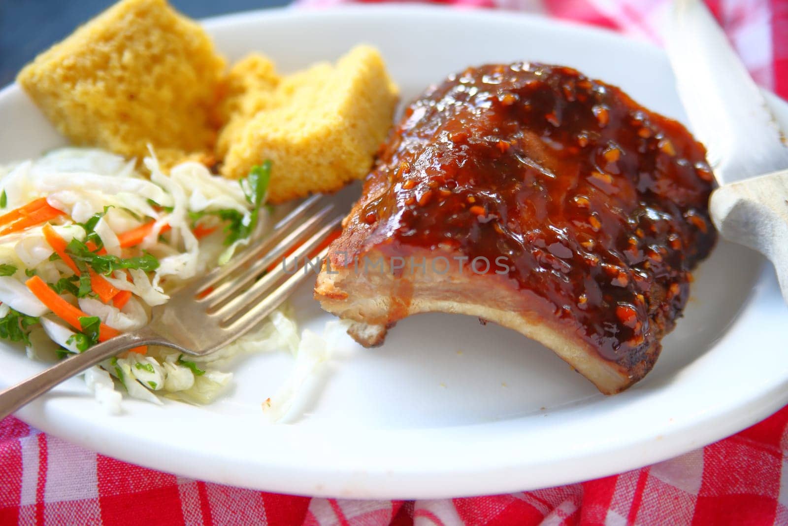 Barbecued baby back ribs with coleslaw and cornbread