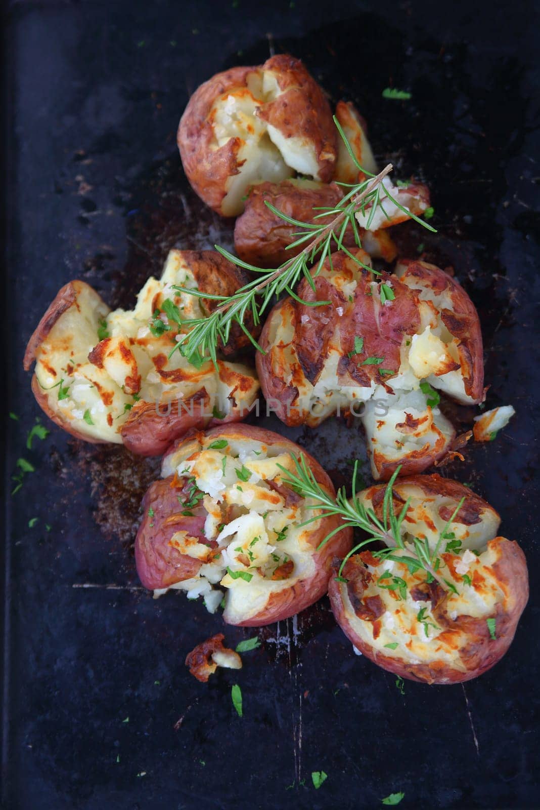 Crushed red potatoes with rosemary sprigs from overhead
