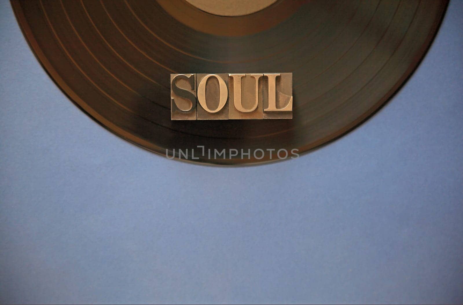 Black vinyl record with the word soul in metal type with room for copy