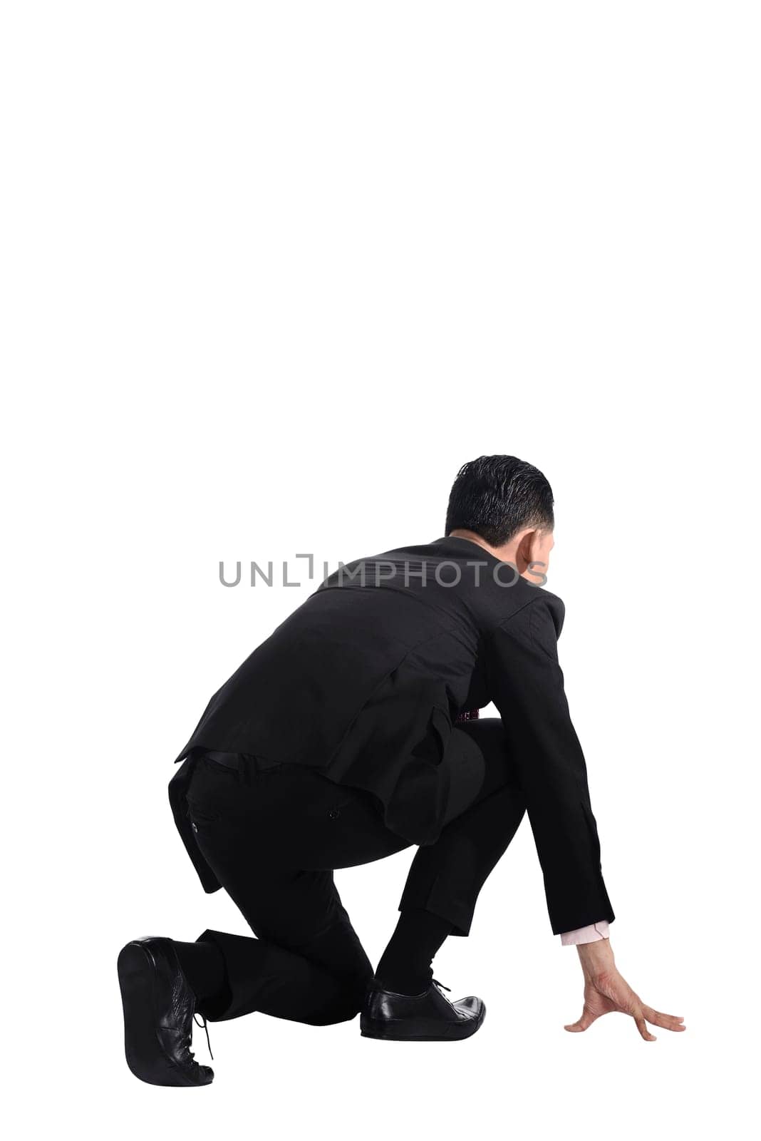 Man kneeling on start position. Businessman ready to start job.