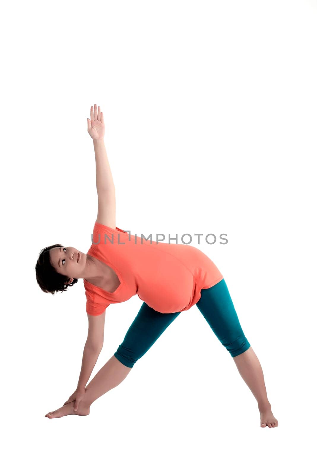Asian pregnant woman doing yoga over isolated white background