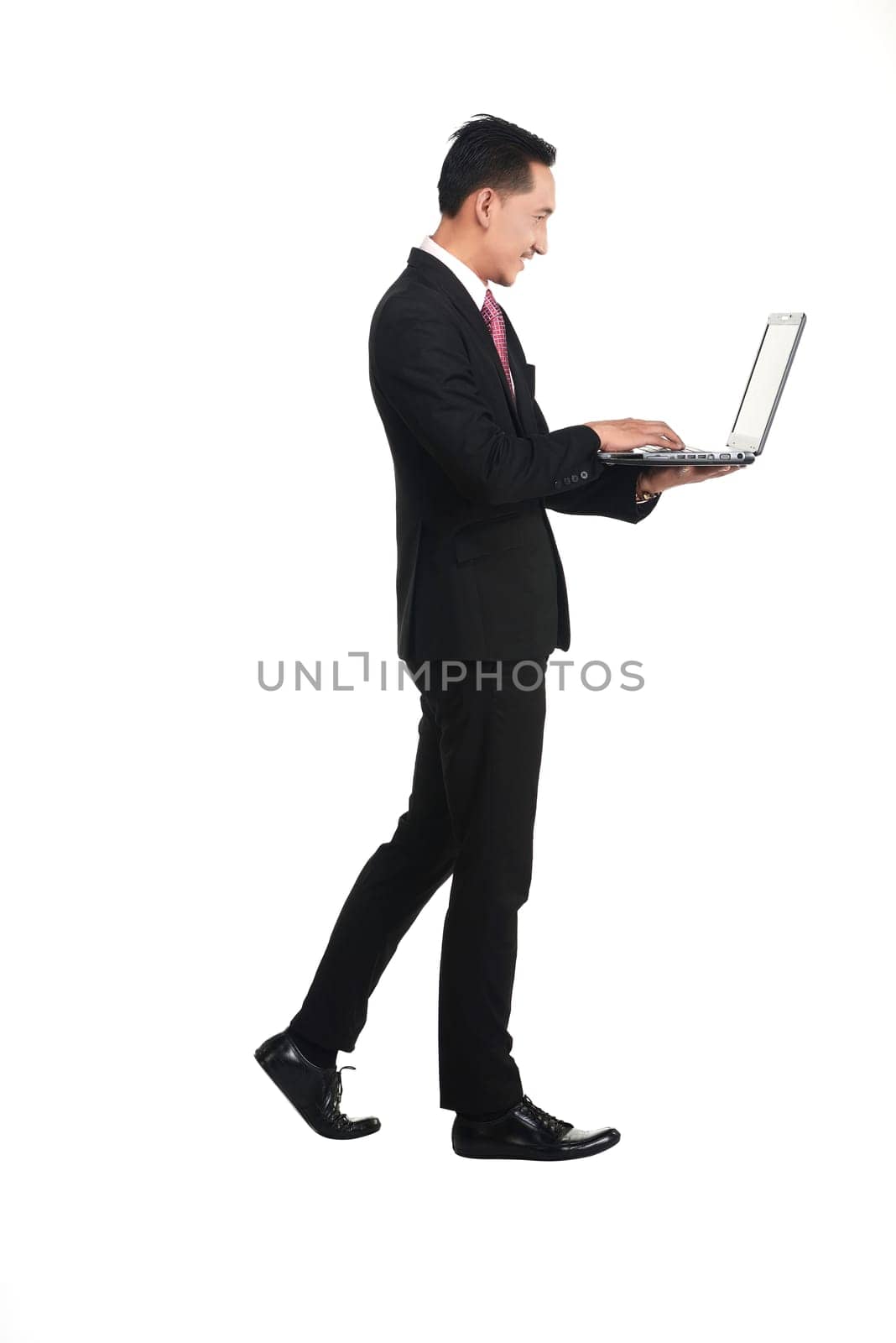Business man standing working with laptop isolated over white background