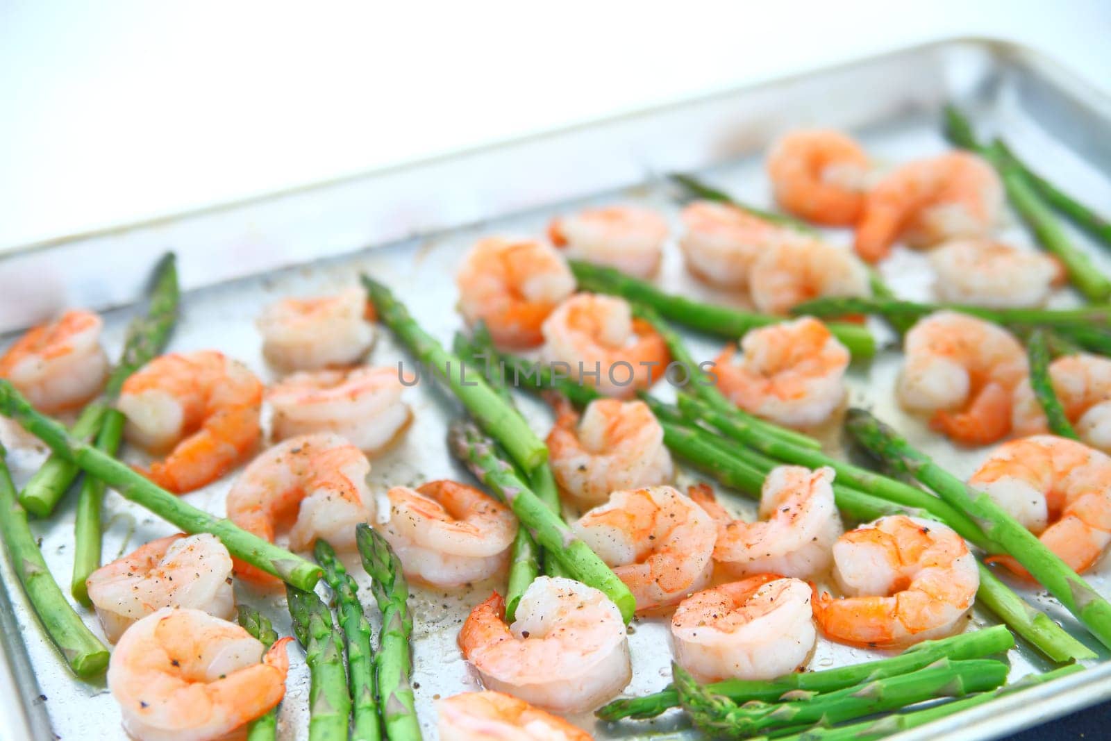 Shrimp and asparagus cook in the oven for a healthy dinner