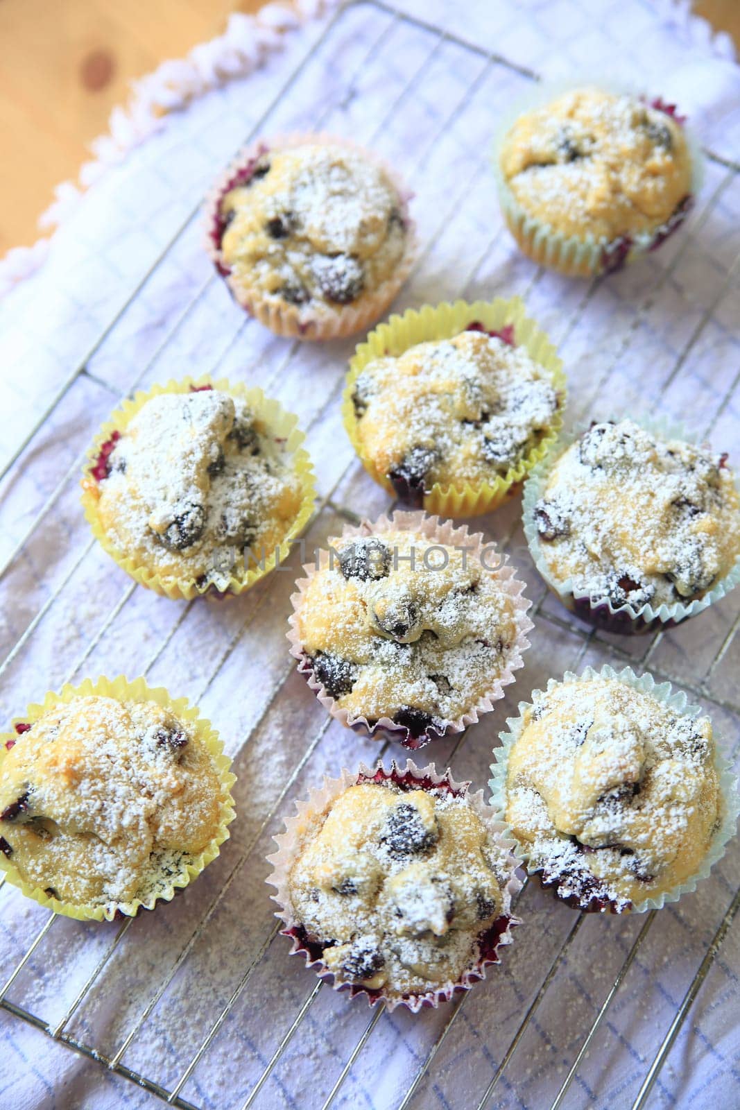 Blueberry muffins, just out of the oven, sprinkled with powdered sugar