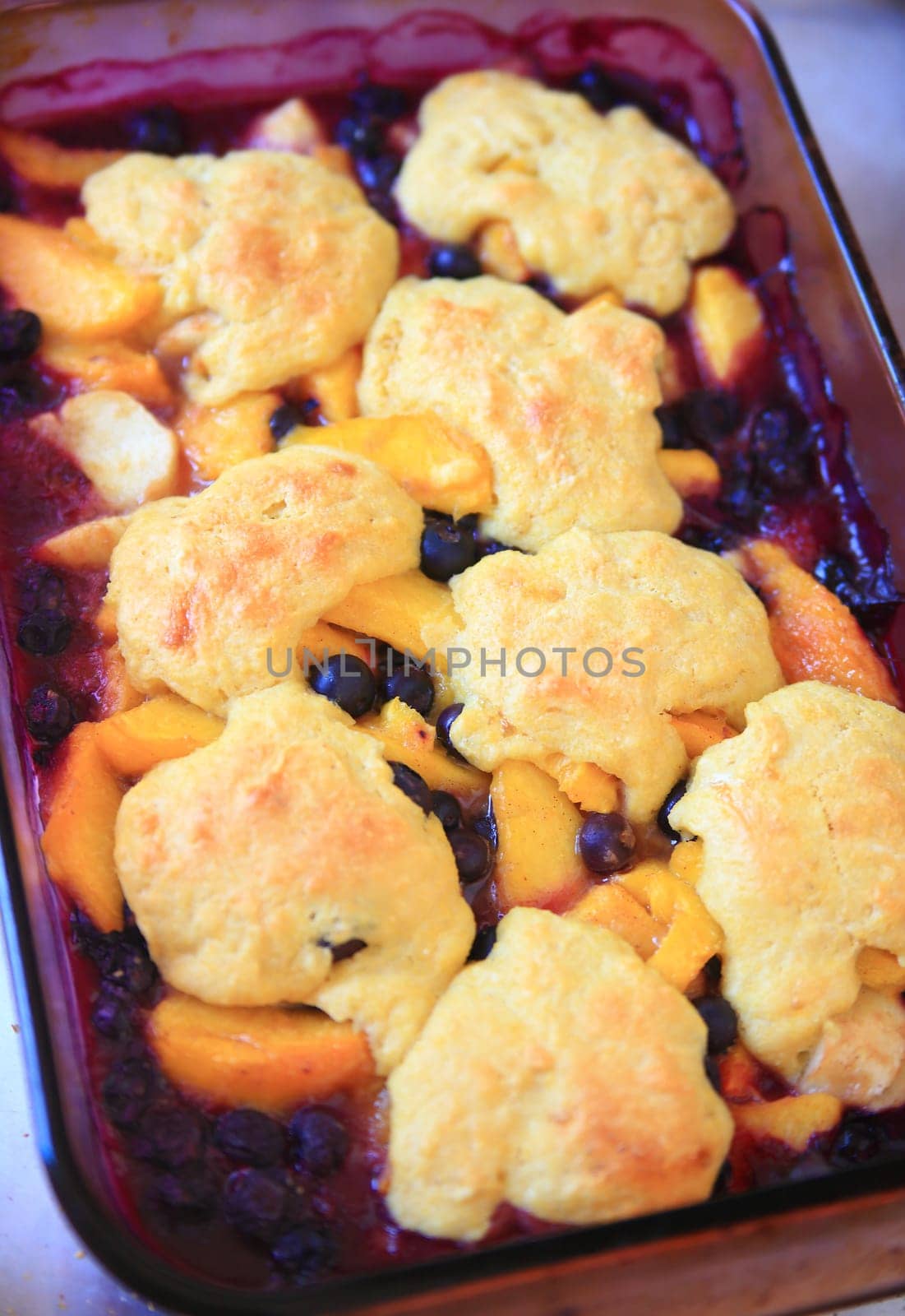 Overhead view of fresh peach and blueberry cobbler