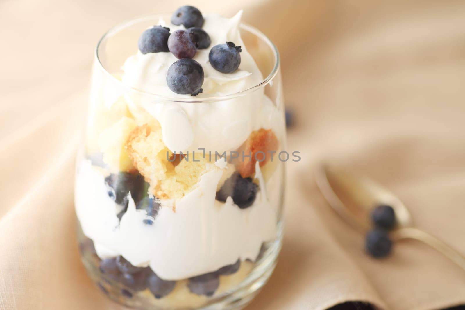 Small, individual trifle dessert made with fresh blueberries, whipped cream and pound cake