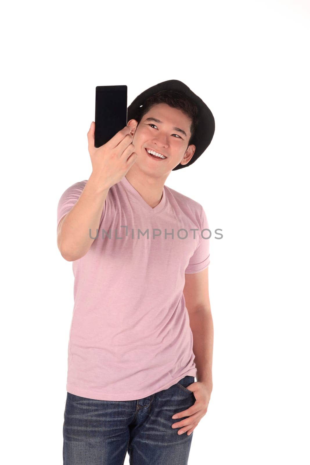 Closeup of young handsome man looking at smartphone and taking selfie