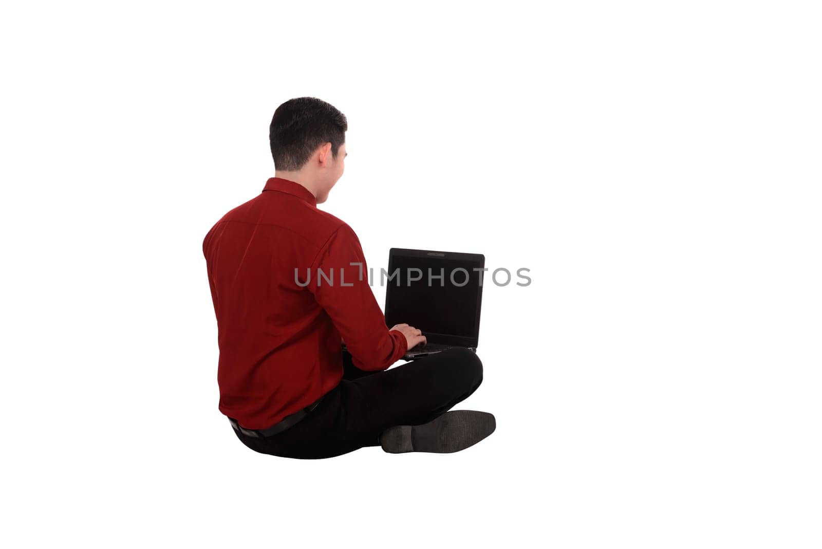 Asian business man working on a laptop and sitting on the floor isolated over white background