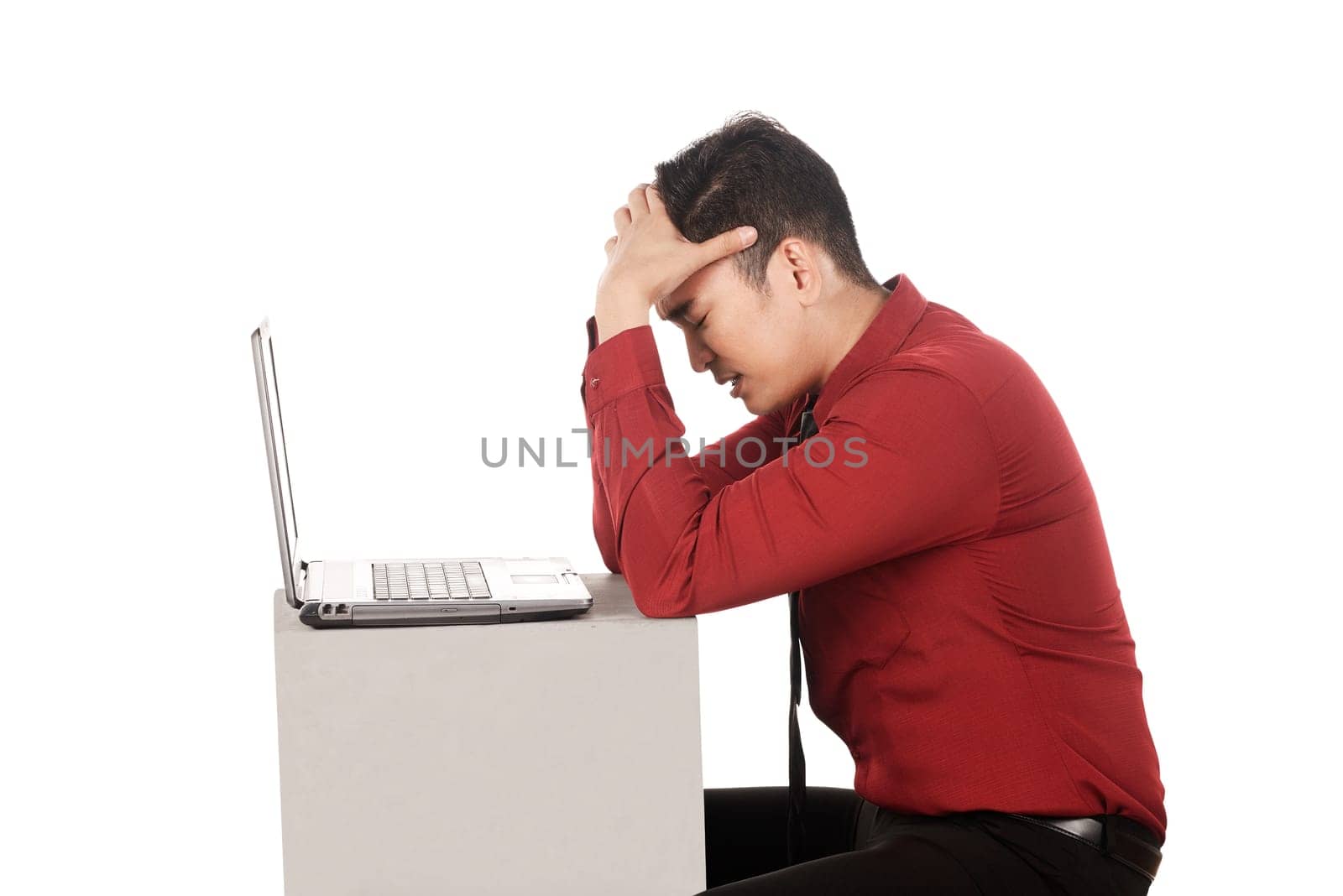 Asian business man stress working with laptop isolated over white background