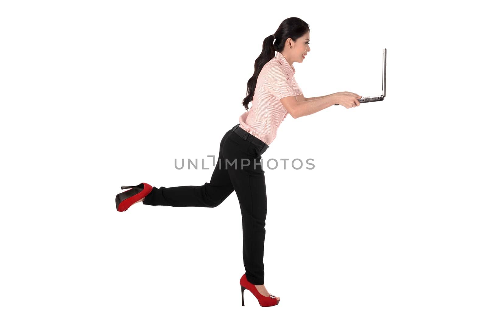 Asian business woman using laptop while running isolated over white background
