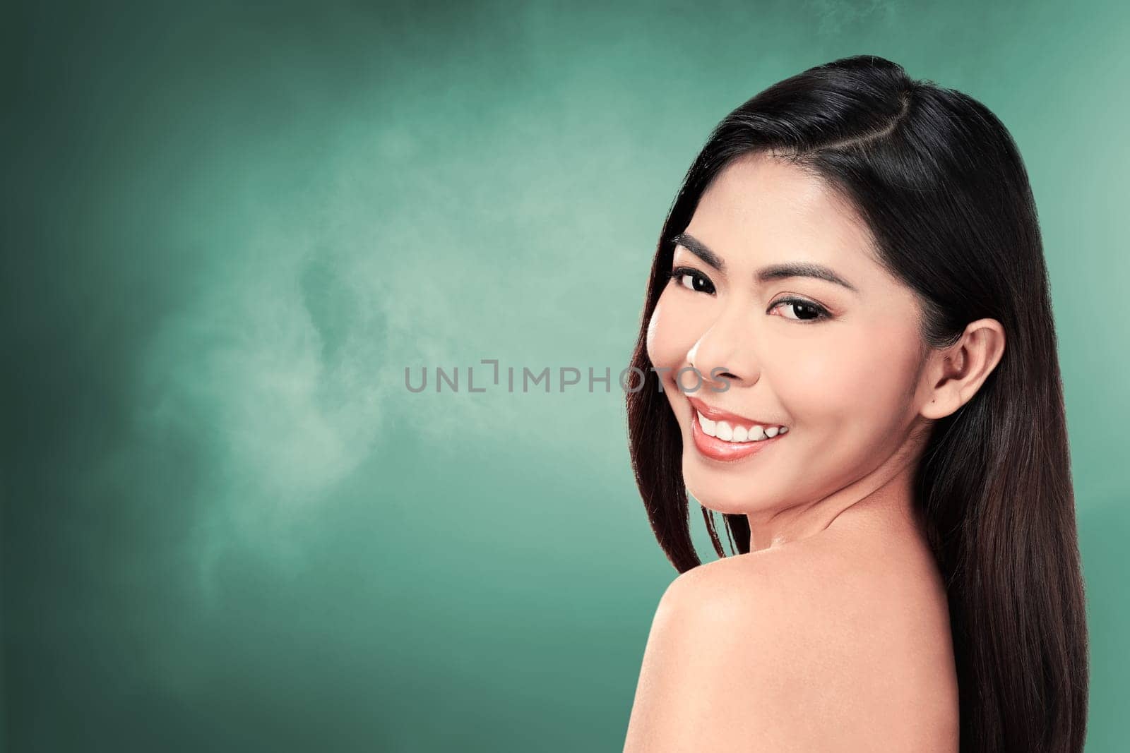 Beautiful face of young adult woman with clean fresh skin over blur background