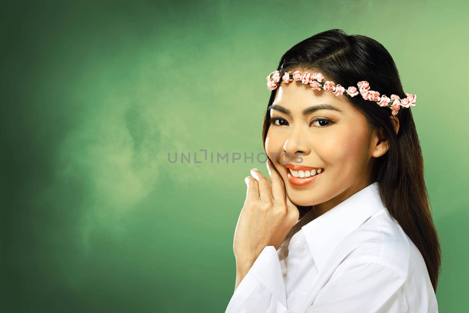 Pretty asian woman wearing flower headband over blur background
