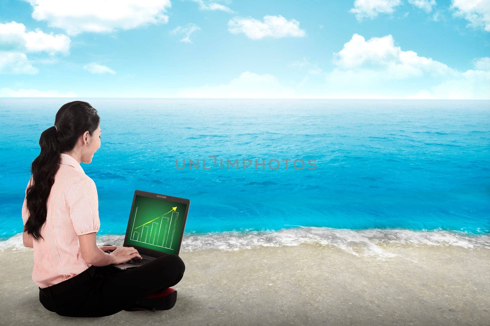 Business woman working on the beach with blue sky background